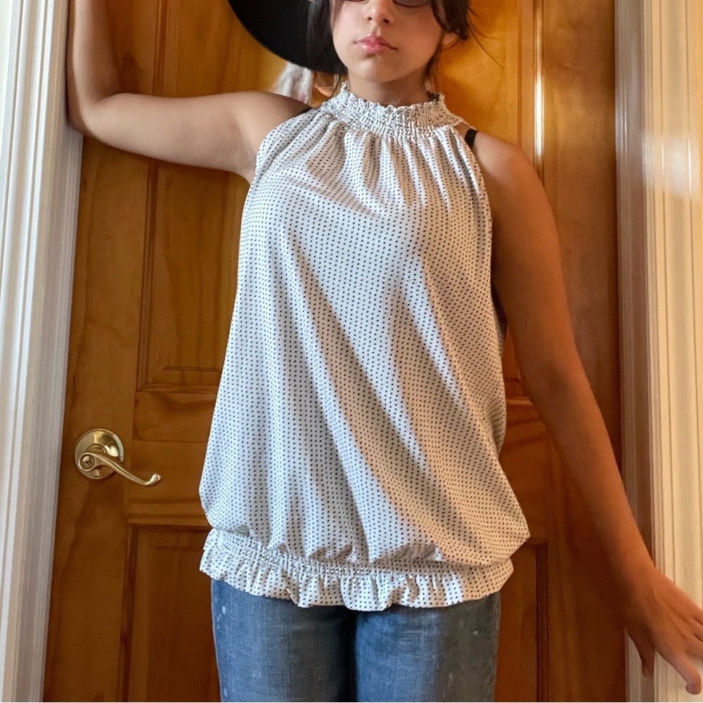 White smocked collar top with black polka dots.